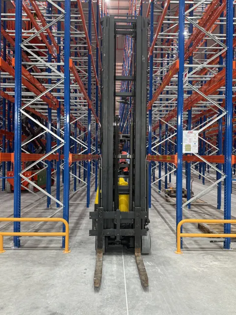 Aisle-Master articulated forklift parked inside a narrow racking aisle