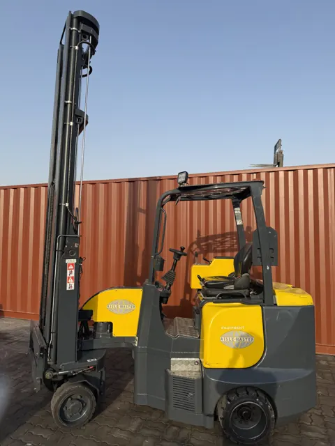 Aisle-Master articulated forklift outdoors next to a shipping container