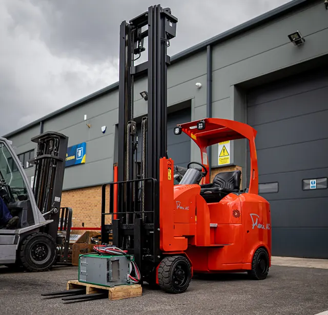 Orange Flexi articulated forklift outside a warehouse