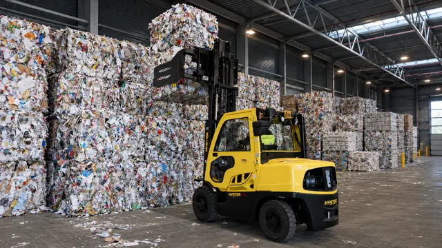 Forklift with a bale clamp handling recycling bales