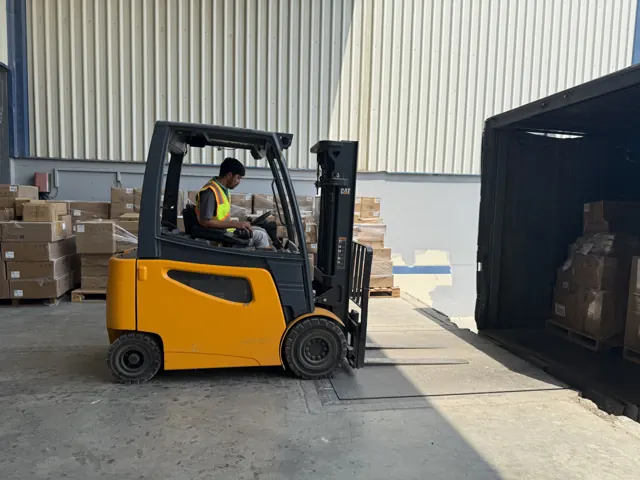 3 ton electric forklift with an operator at a container loading door