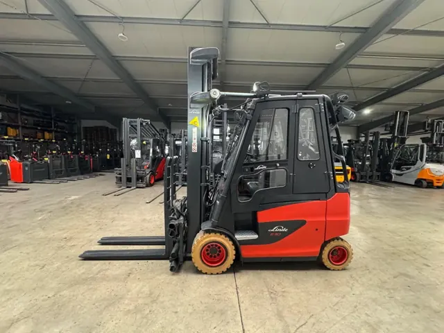 Linde electric forklift with a cab in a large warehouse