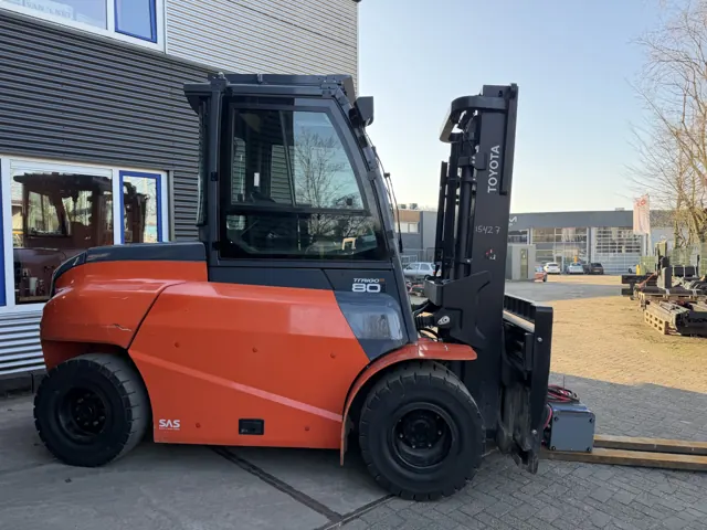 Toyota 8 ton electric forklift with an enclosed cab, side view