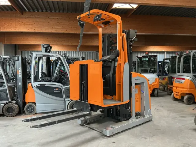 Orange order picker in a workshop