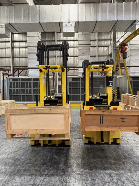 Two order pickers with crates on the forks, front view