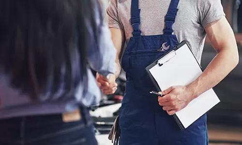 Forklift maintenance technician with checklist