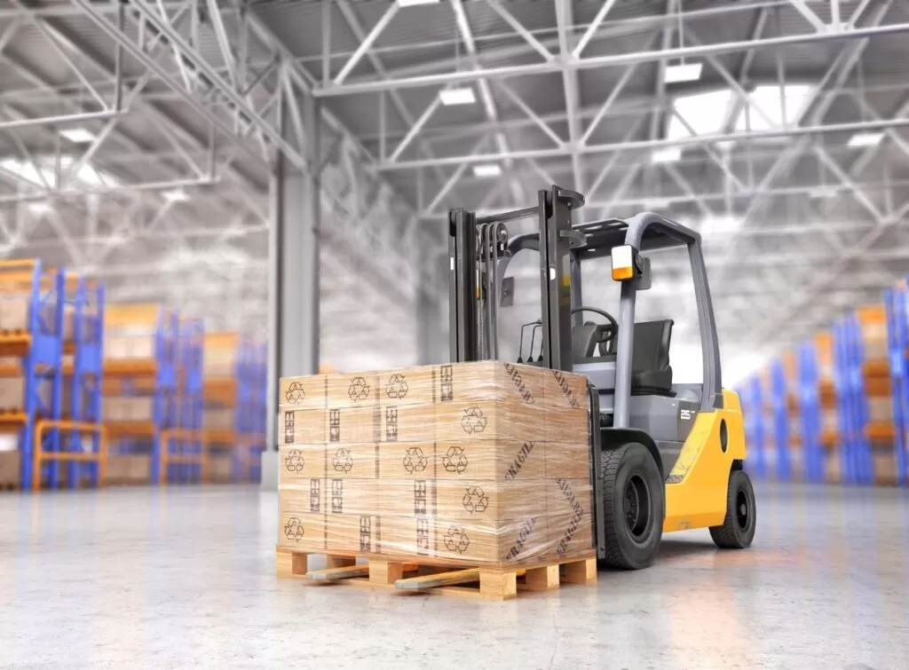 Forklift transporting a pallet in a warehouse