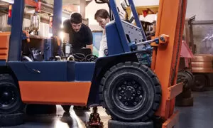 Forklift maintenance technician with checklist