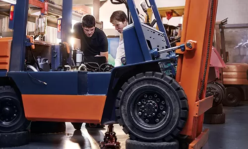 Forklift maintenance technician with checklist