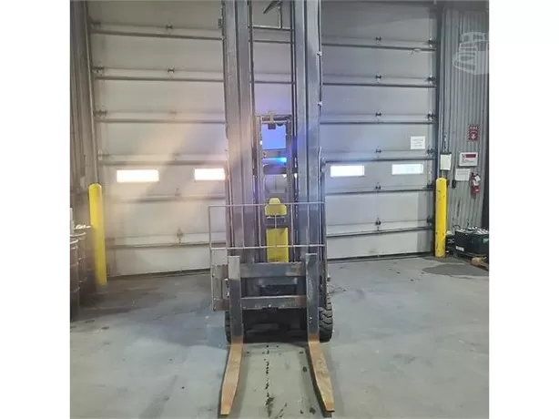 Electric reach forklift operating in warehouse
