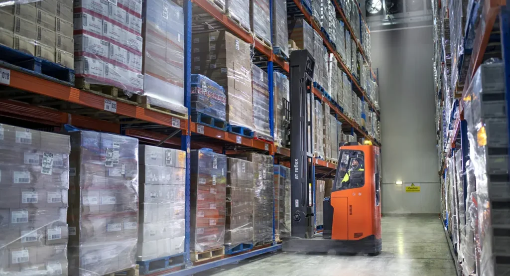 Reach truck working in a cold store racking aisle