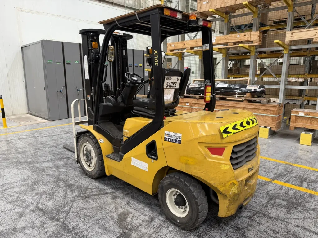 Diesel counterbalance forklift in front of adjustable pallet racking